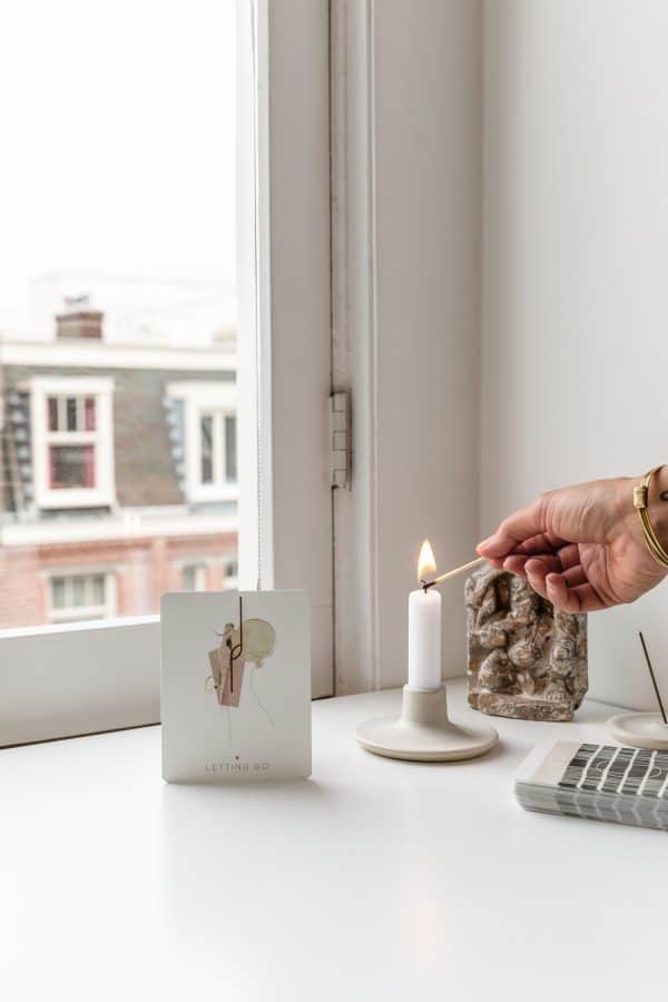 Inner Compass card Letting Go together with a candle