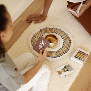 A girl doing a card reading with the Kids cards