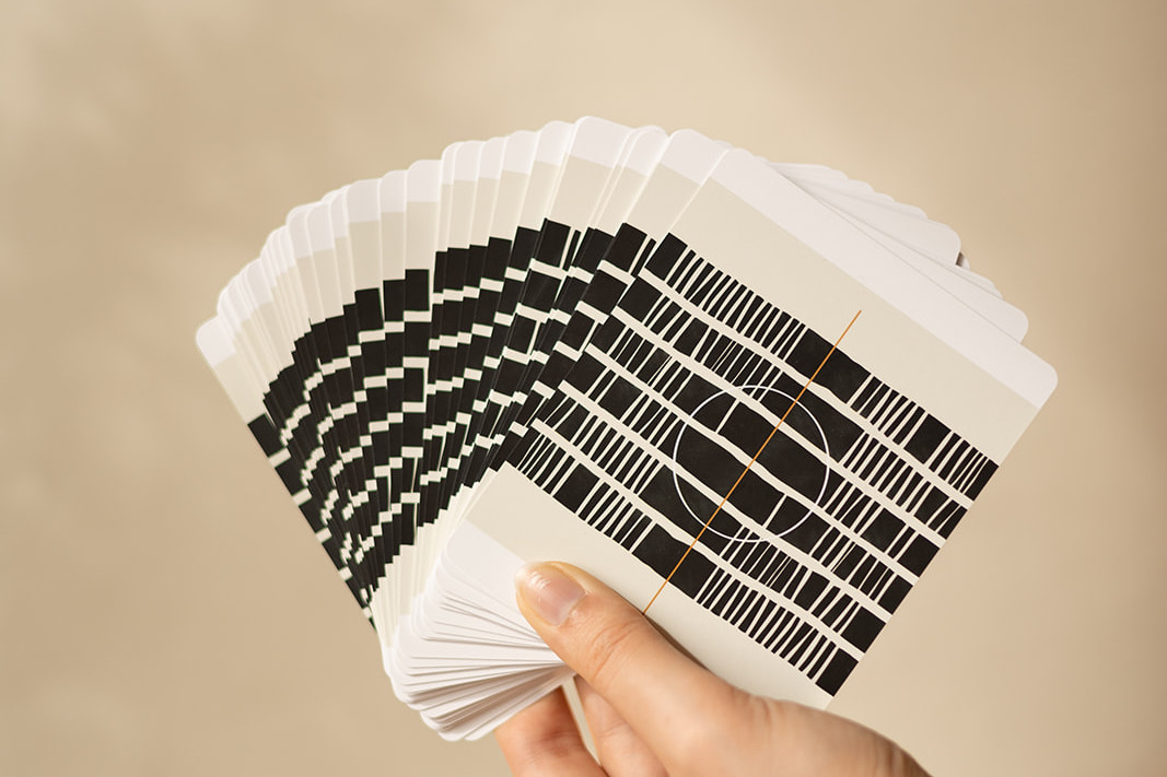 A hand showing the backside of the original Inner Compass cards