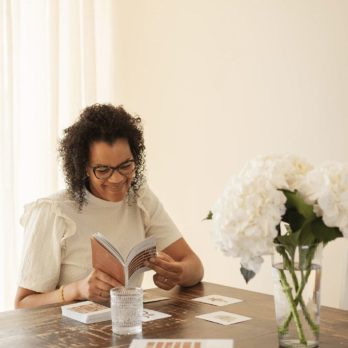 A woman reading the booklet of the Inner Compass - Kids cards